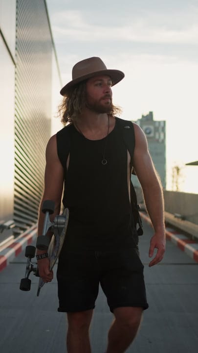 Sunset Stroll With Skateboard In Hand