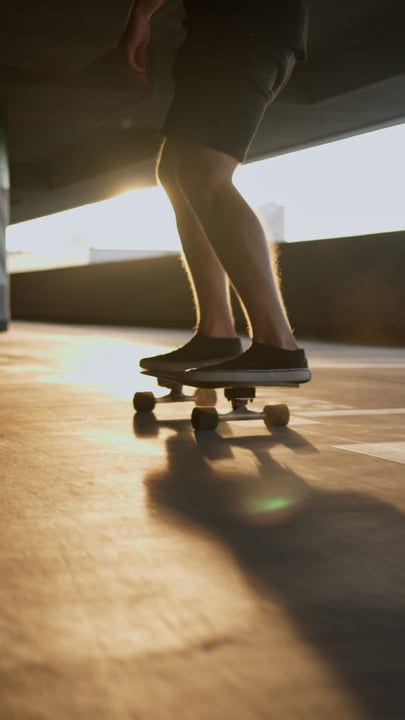 Skater Glides Through the City At Sunset Glow