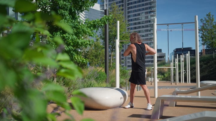 Skater Prepares For Urban Workout Against Cityscape Backdrop
