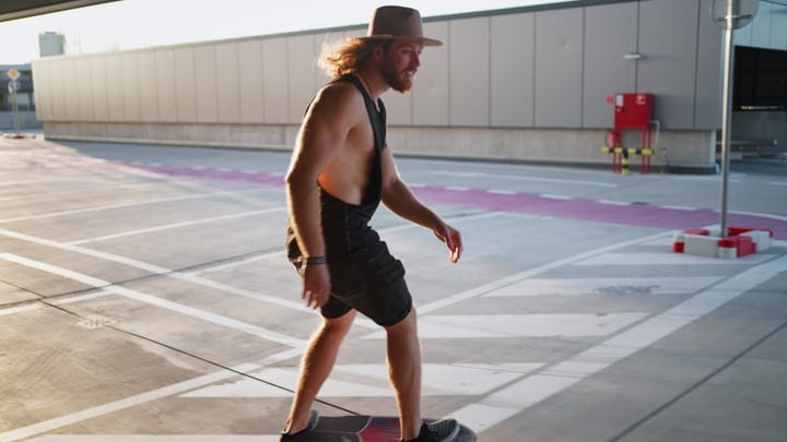 Skater Embraces the Freedom of Urban Sunset Skies
