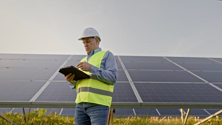 Engineer Conducts Solar Panel Inspection at Dawn