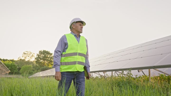 Seasoned Engineer Surveys the Solar Panel Array