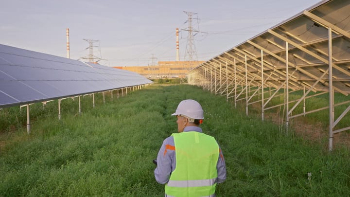 Engineer Surveys Solar Panels On A Sunny Day
