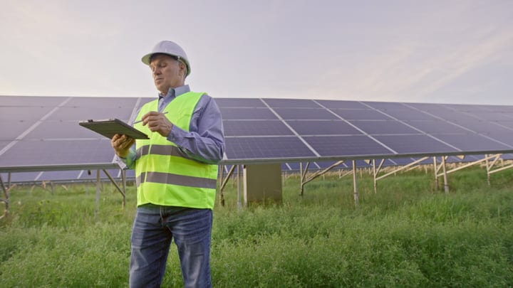 Engineer Conducts Solar Panel Inspection On A Sunny Day