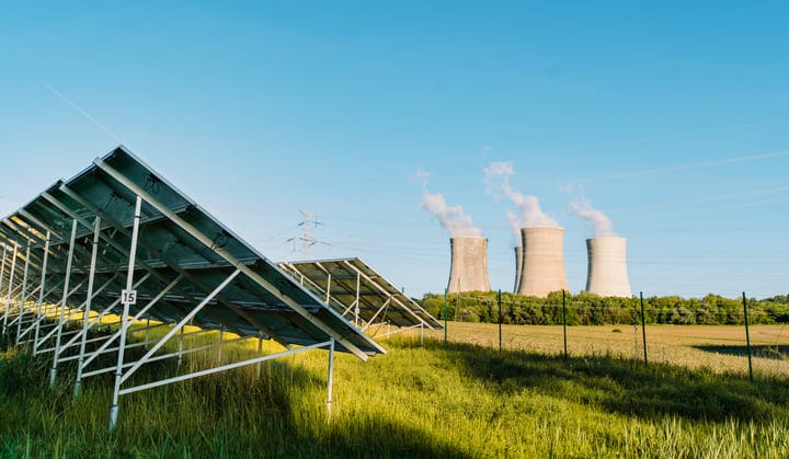 Solar Panels Stand Tall Against Industrial Backdrop