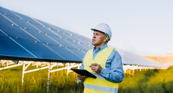 Seasoned Engineer Reviews Solar Panels At Sunrise