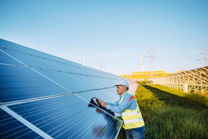 Engineer Conducts Solar Panel Inspection on Sunny Day