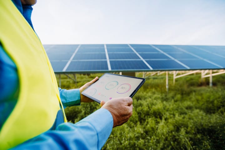 Engineer Surveys Solar Panels With Digital Precision