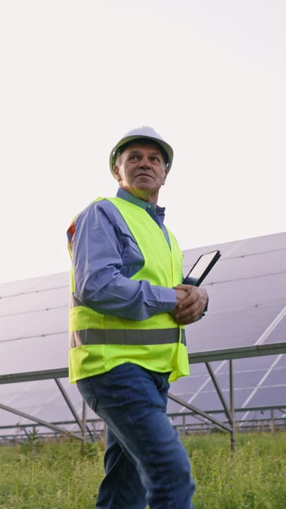 Solar Engineer Surveys Panels Under An Open Sky