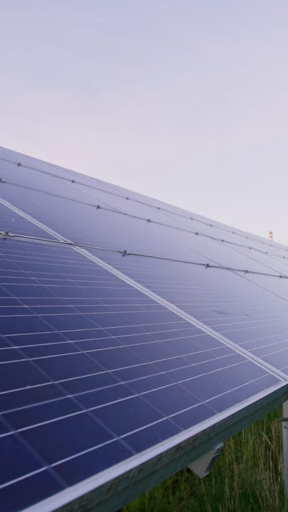 Sunlight Reflects Off Solar Panels Under Clear Sky