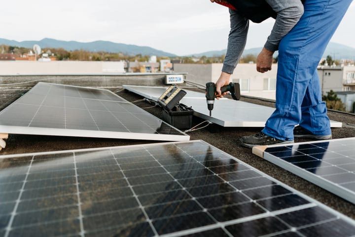 Harnessing Solar Power On A Rooftop Under Blue Skies