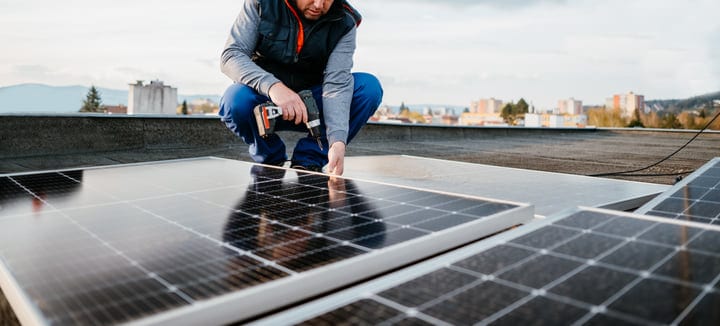Hands-On Precision: Engineer Adjusts Solar Panels On Rooftop