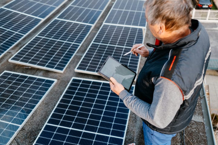 Modern Engineer Analyzes Solar Panels With a Tablet in Hand