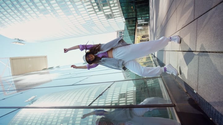 Street Dancer Leaps Against Urban Reflections