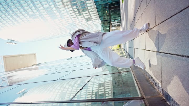 Urban Dancer Leaps Skyward Against Glass Facades