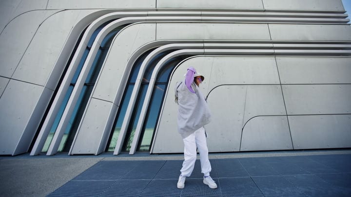 Urban Dancer Moves with Grace Against Futuristic Backdrop