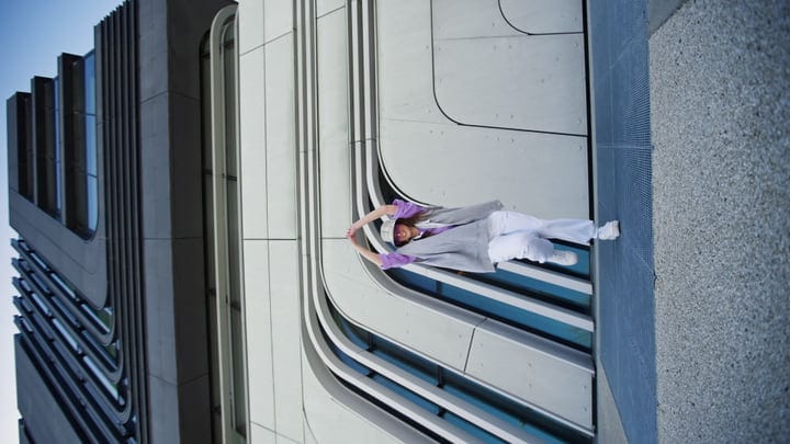 Urban Dancer Defies Gravity Against Geometric Facade