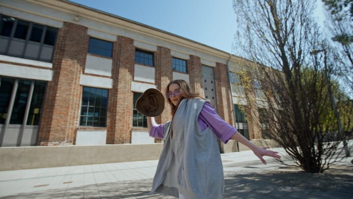 Urban Dancer Twirls Gracefully In Sunlit Cityscape