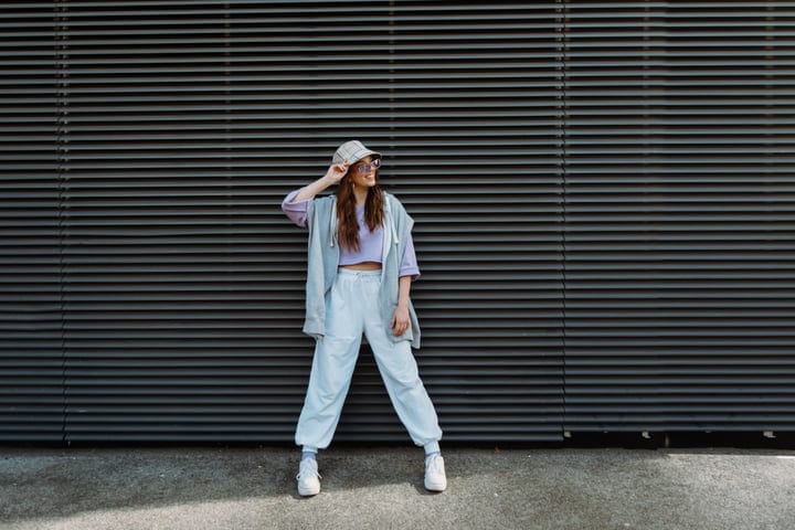 Youthful Expression In Street Fashion Against Urban Backdrop