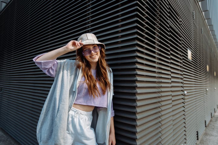 Urban Dancer Smiles Against Modern Architectural Backdrop