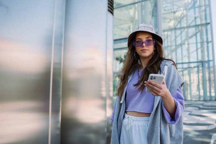 Youthful Style Meets Urban Reflections In Sunlit Cityscape