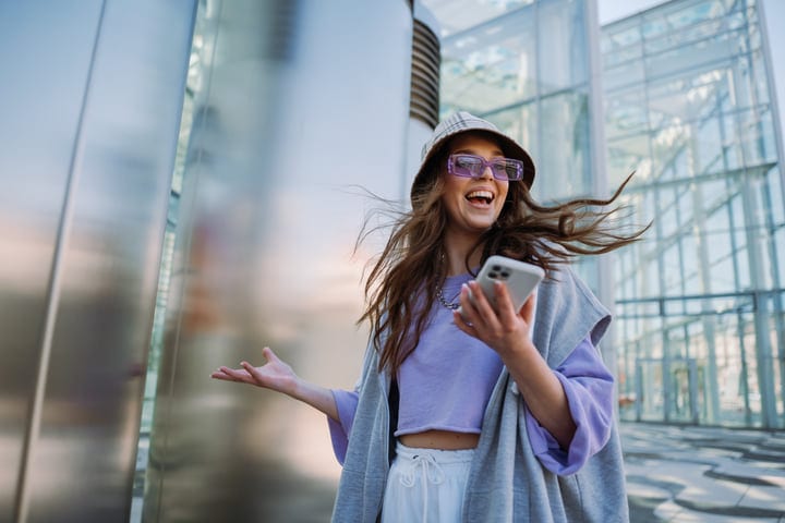 Joyful Expression Of A Stylish Young Woman Outdoors