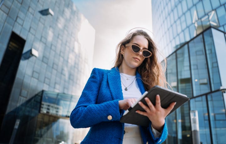 Confident Professional Engages With Technology in Urban Setting