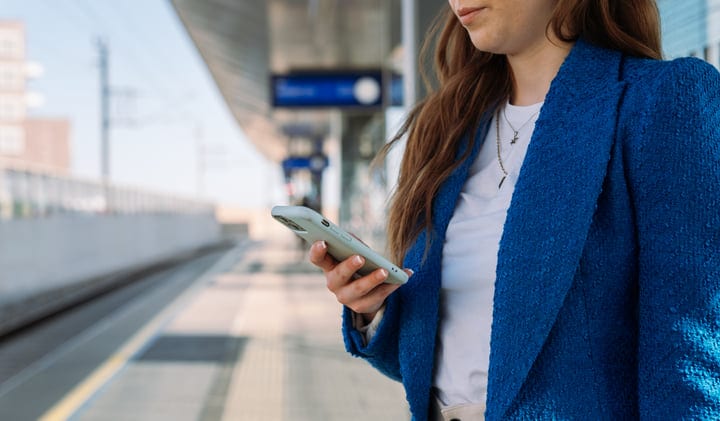 Modern Commuter Checking Her Phone At The Station