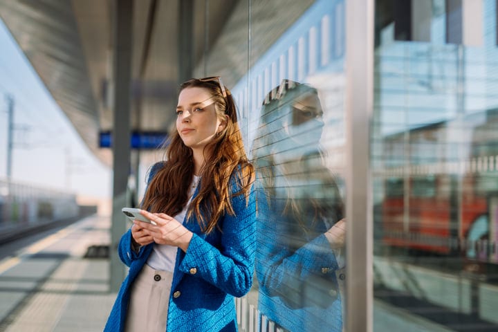 Reflections Of A Woman Waiting In Urban Transit