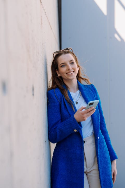 Young Woman Enjoys A Sunny Day With Her Phone