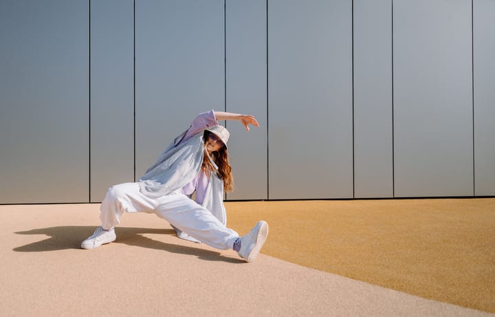 Graceful Street Dance Moves Against Urban Backdrop