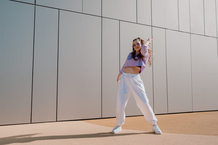 A Young Dancer Expresses Joy on City Streets