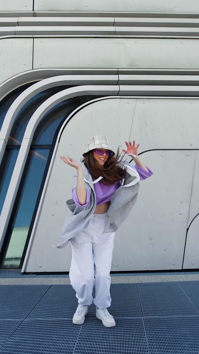 Vibrant Street Dancer Moves Against Urban Backdrop