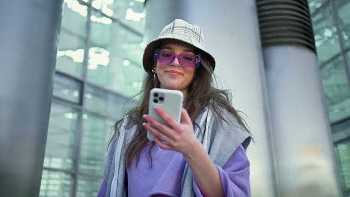 Young Woman Engages Digitally In Urban Setting