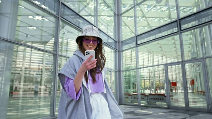 Joyful Moment As Trendy Young Woman Checks Her Phone