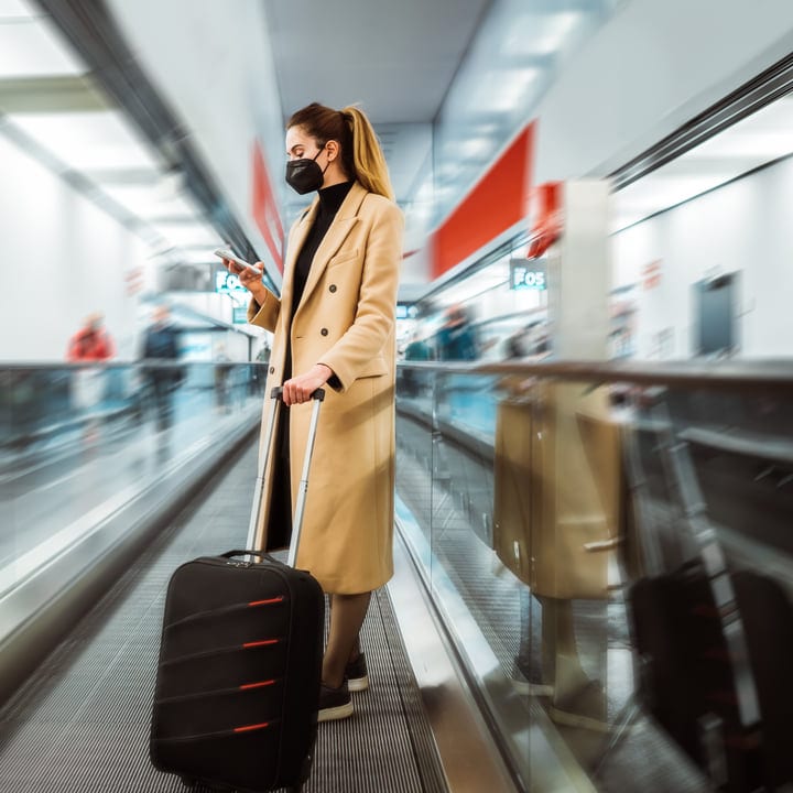 Traveler Navigates Airport Terminal With Graceful Poise