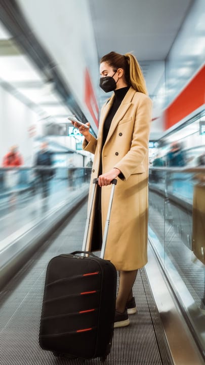 Traveler Navigates Busy Airport With Determination And Style