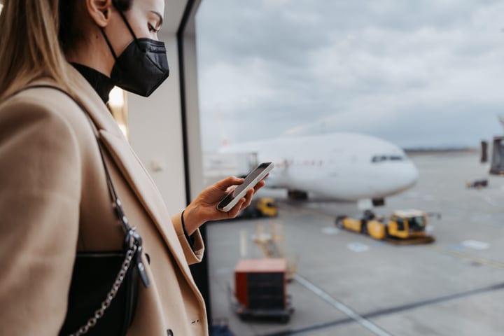 Traveler Connects with the World at Airport Terminal