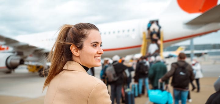 Smiling Traveler Embarks On A New Journey At The Airport