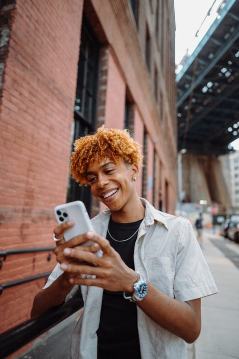 Young Man Enjoys A Digital Moment On NYC Street