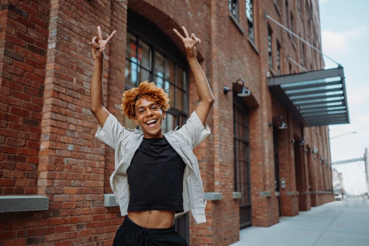 Joyful Youth Celebrating in a Brick-Laden Urban Street