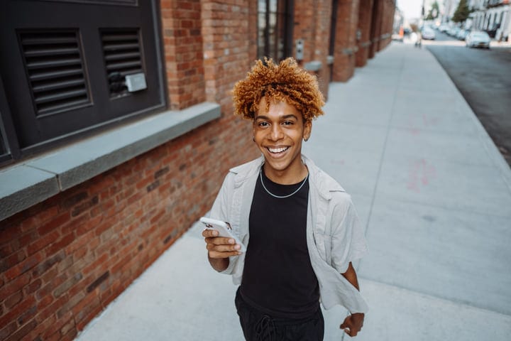 Joyful Walk With Smartphone Down City Street