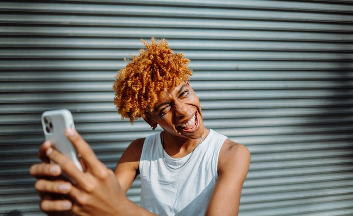 Vibrant Youth Captures Joyful Selfie On Urban Street