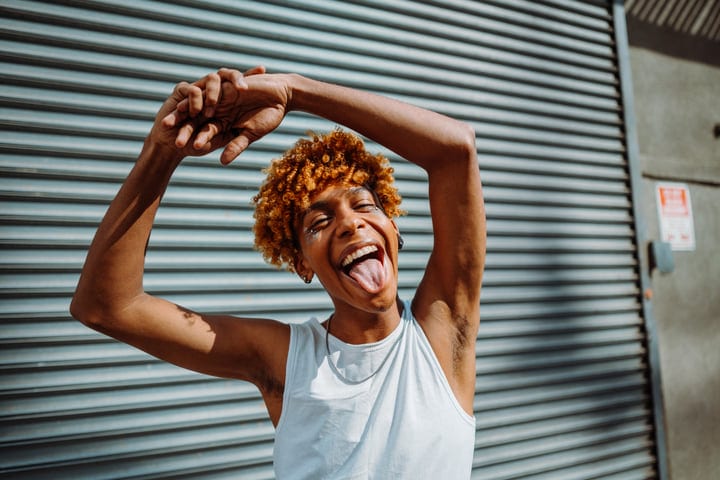 Confident Youth Expressing Joy In Sunlit NYC Alley
