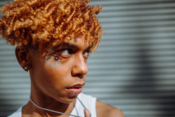 Sunlit Reflection: A Youthful Gaze in Urban NYC