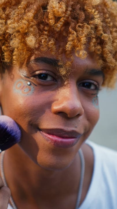 Joyful Expression With Vibrant Makeup In Urban Setting