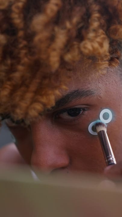 Close Up of Youth Applying Makeup in Vibrant NYC Setting