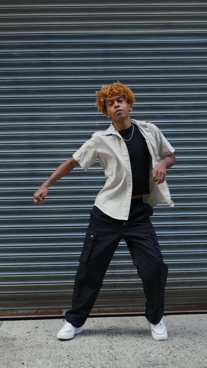 Energetic Youth Dancing Against Urban Backdrop