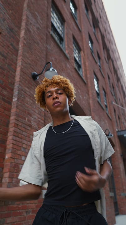 Confident Youth Walking Through Urban Brick Alley