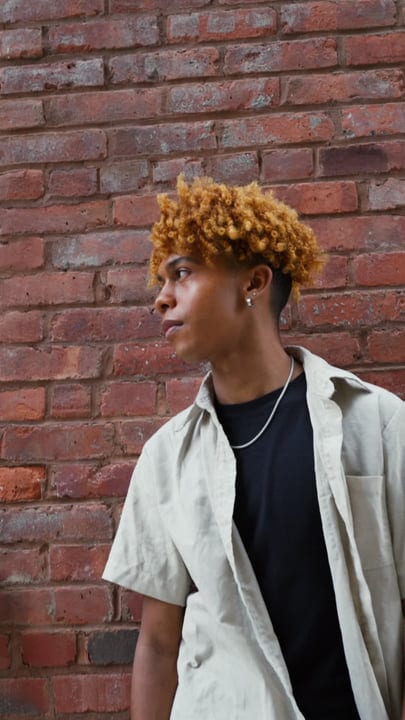Contemplative Youth Against Urban Brick Wall in NYC